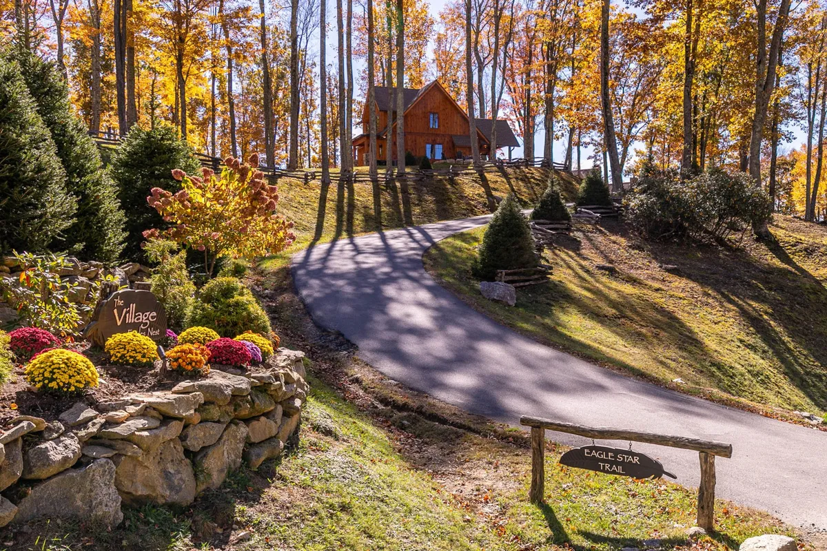 The image shows the exterior of the house with a welcoming pathway, colorful flowers, and clear signage. The setting highlights easy access to walking paths and a vibe of exploration, aligning with the section's focus on adventure and outside activities with pets.